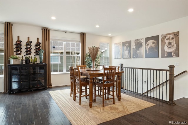 dining space with recessed lighting, baseboards, and wood finished floors