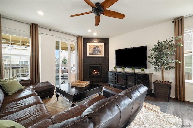 living area featuring ceiling fan, a fireplace, wood finished floors, and recessed lighting