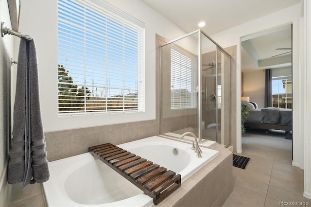 full bathroom featuring a stall shower, tile patterned floors, a bath, and ensuite bathroom