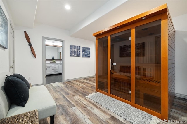 interior space featuring recessed lighting, a sauna, baseboards, and wood finished floors