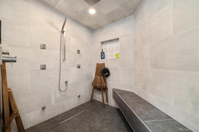 full bath featuring tile patterned floors, recessed lighting, tile walls, and tiled shower