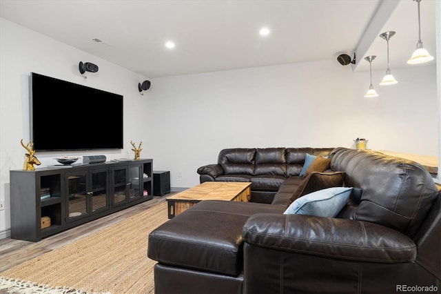 living room with light wood-type flooring and recessed lighting