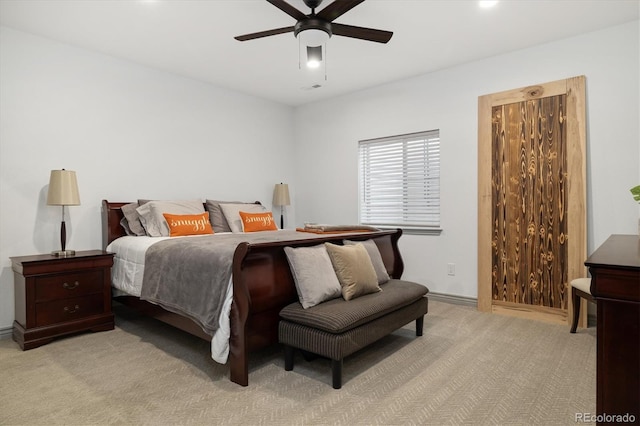 bedroom featuring baseboards, ceiling fan, visible vents, and light colored carpet