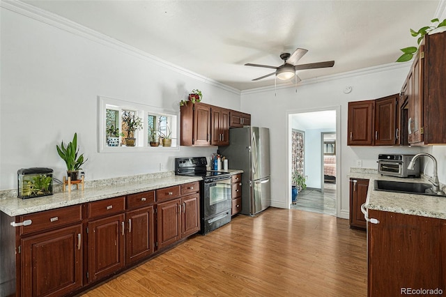 3768 S Acoma St, Englewood, CO 80110 - kitchen featuring ceiling fan, black electric range oven, a sink, freestanding refrigerator, and light wood-style floors