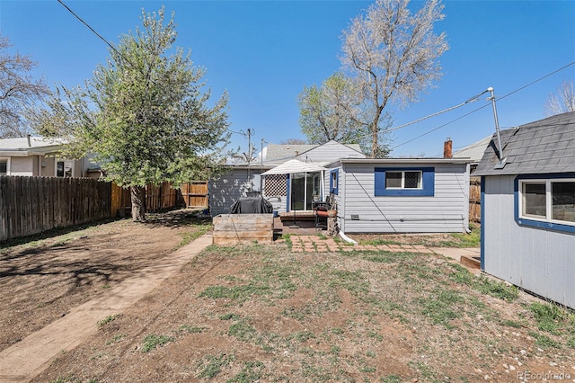 3768 S Acoma St, Englewood, CO 80110 - back of property with a patio, an outbuilding, a fenced backyard, and a shed