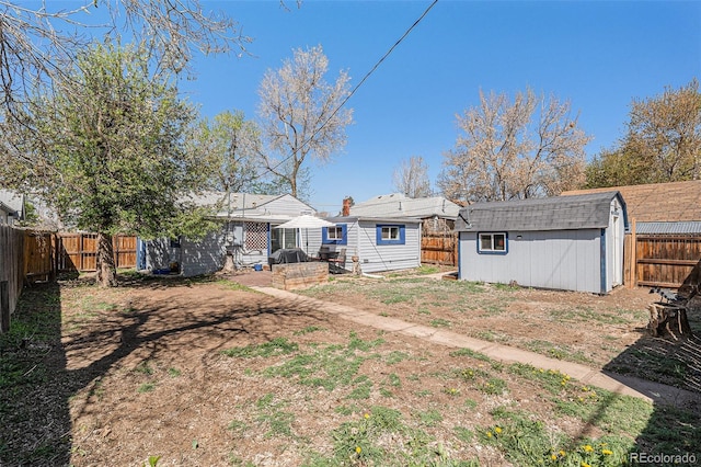 3768 S Acoma St, Englewood, CO 80110 - view of yard with a storage unit, a fenced backyard, and an outdoor structure