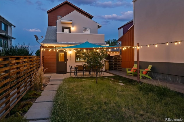 view of front of house with a patio and a front yard