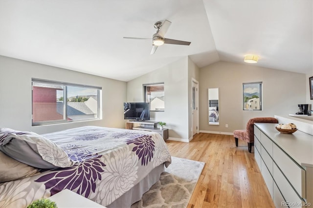 bedroom featuring ceiling fan, lofted ceiling, and light hardwood / wood-style floors