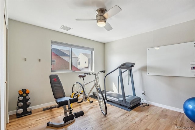 workout area with light hardwood / wood-style floors and ceiling fan