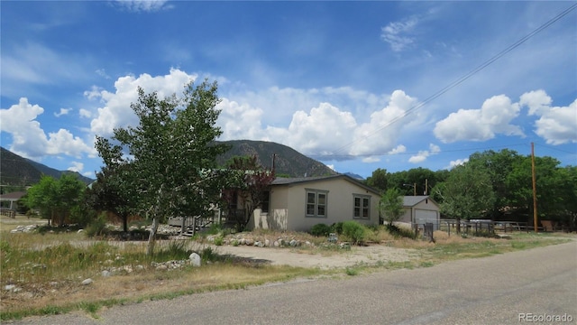 150 Palmer Ave, Poncha Springs, CO 81242 - view of side of property with a mountain view, stucco siding, and a garage
