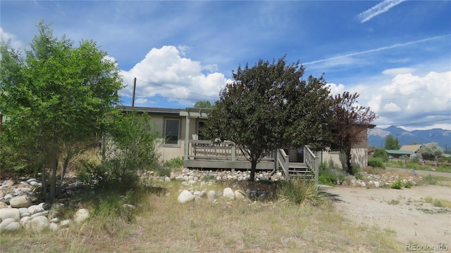 150 Palmer Ave, Poncha Springs, CO 81242 - rear view of property with stucco siding and a deck with mountain view