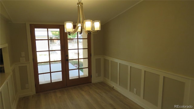 150 Palmer Ave, Poncha Springs, CO 81242 - doorway with a decorative wall, a chandelier, wood finished floors, french doors, and a wainscoted wall