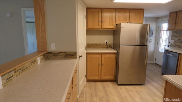 150 Palmer Ave, Poncha Springs, CO 81242 - kitchen with appliances with stainless steel finishes, backsplash, light wood-style floors, and light countertops