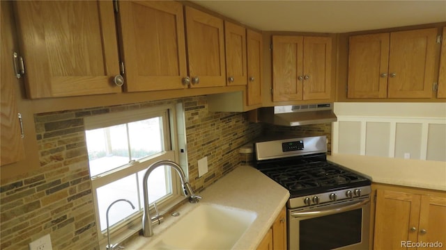 150 Palmer Ave, Poncha Springs, CO 81242 - kitchen with gas range, under cabinet range hood, decorative backsplash, and light countertops