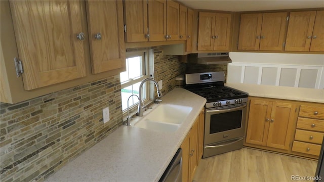 150 Palmer Ave, Poncha Springs, CO 81242 - kitchen featuring appliances with stainless steel finishes, under cabinet range hood, brown cabinetry, and backsplash