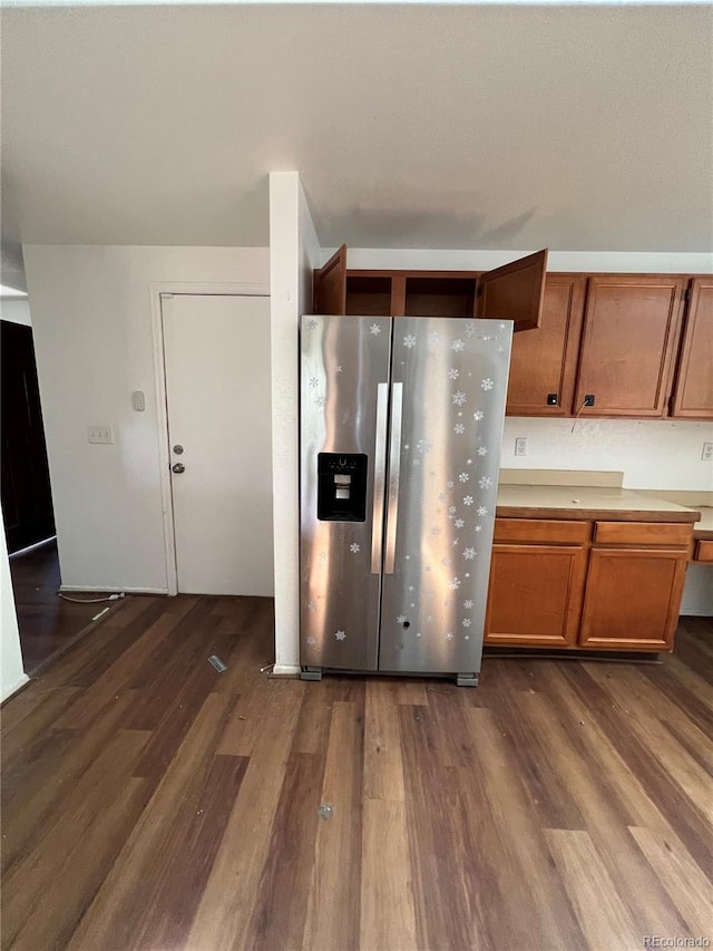 kitchen featuring stainless steel refrigerator with ice dispenser and dark wood-type flooring