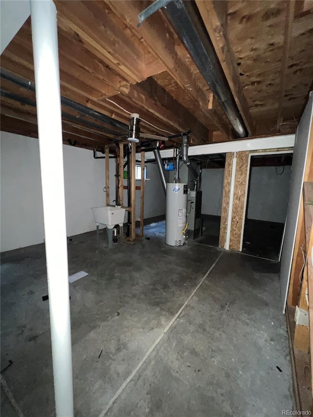 basement featuring sink and water heater