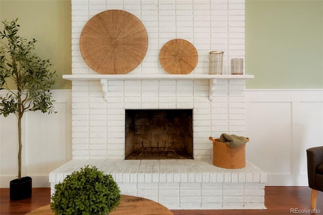 details with hardwood / wood-style floors and a fireplace