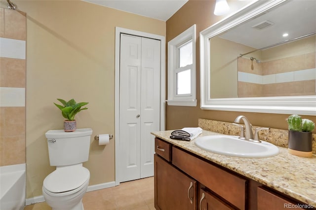 full bathroom featuring tile patterned flooring, vanity, tiled shower / bath combo, and toilet