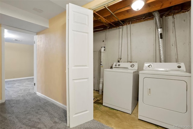 washroom with light colored carpet and washing machine and clothes dryer