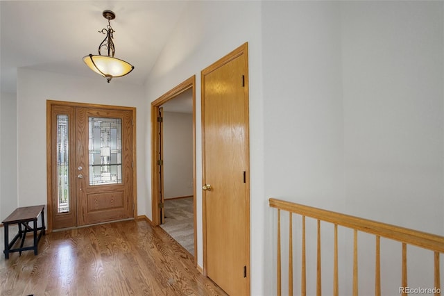 foyer featuring light wood-style flooring and baseboards
