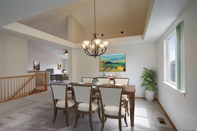 dining room featuring carpet flooring, healthy amount of natural light, a chandelier, ceiling fan, and lofted ceiling