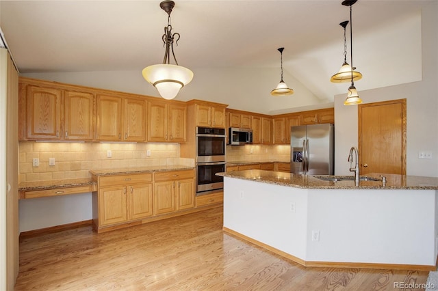 kitchen with stainless steel appliances, a sink, vaulted ceiling, decorative backsplash, and stone counters
