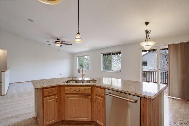 kitchen featuring stainless steel dishwasher, a sink, light stone countertops, and ceiling fan
