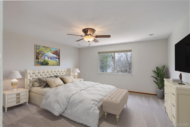 bedroom featuring light colored carpet, ceiling fan, and baseboards