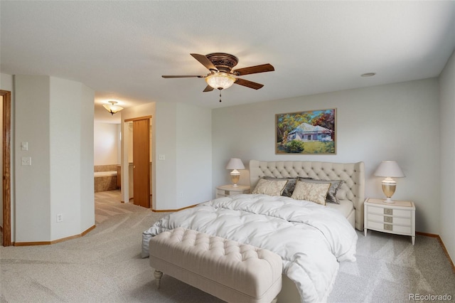 carpeted bedroom featuring baseboards, connected bathroom, and a ceiling fan