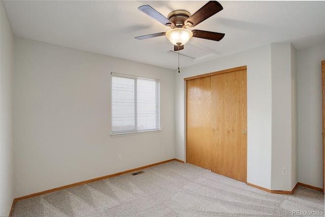unfurnished bedroom with carpet flooring, a closet, and baseboards