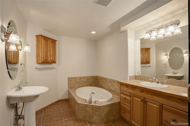 full bathroom with tile patterned flooring, a garden tub, two sinks, baseboards, and recessed lighting