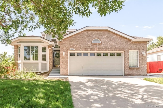 5282 E 116th Ave, Thornton, CO 80233 - view of front of home featuring brick siding, driveway, and a garage