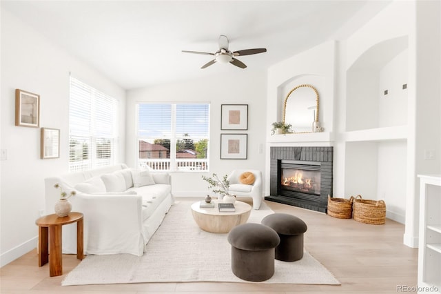 5282 E 116th Ave, Thornton, CO 80233 - living area with a fireplace, a ceiling fan, wood finished floors, and vaulted ceiling