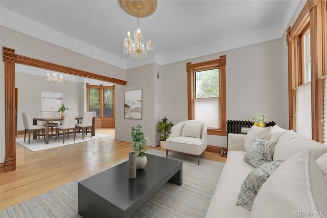 living room featuring an inviting chandelier and light wood-style flooring