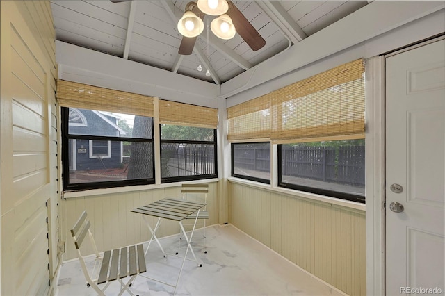 sunroom / solarium featuring wooden ceiling, vaulted ceiling with beams, and a ceiling fan