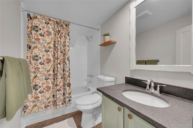 bathroom featuring visible vents, toilet, tile patterned floors, shower / bath combination with curtain, and vanity