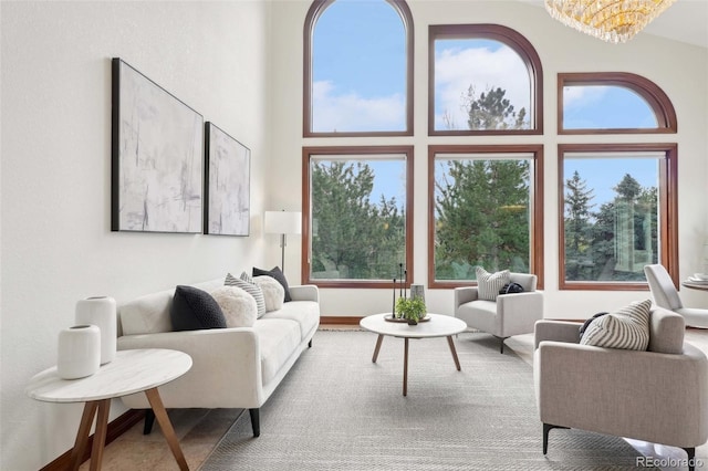 living area featuring an inviting chandelier and a towering ceiling