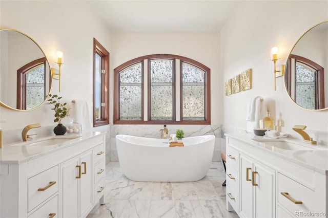 full bath with a wealth of natural light, a sink, and marble finish floor