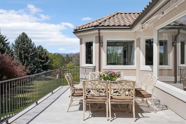 view of patio / terrace featuring outdoor dining area and a balcony