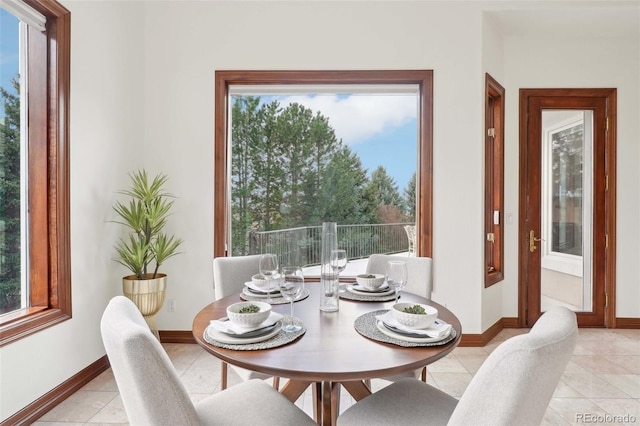 dining room with baseboards and light tile patterned flooring