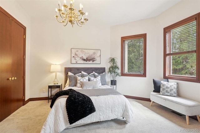 carpeted bedroom with baseboards and a notable chandelier