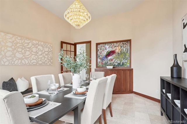 dining area featuring baseboards and a chandelier