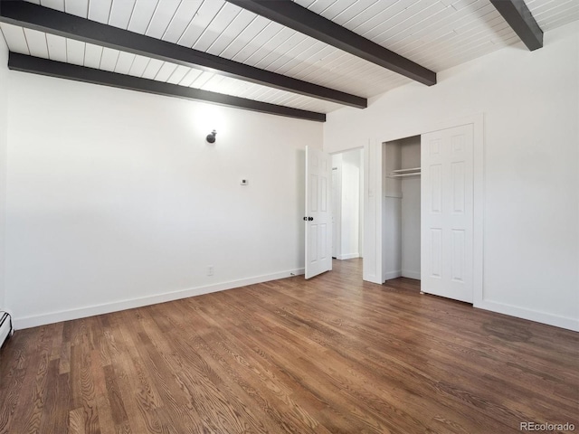 unfurnished bedroom featuring beam ceiling, a closet, and hardwood / wood-style flooring