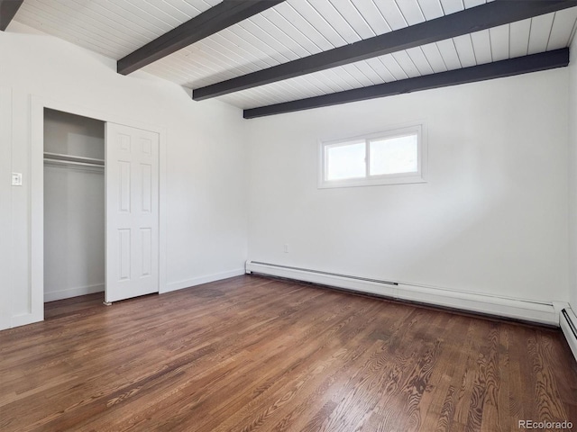 unfurnished bedroom featuring dark hardwood / wood-style floors, a closet, a baseboard heating unit, beam ceiling, and wooden ceiling