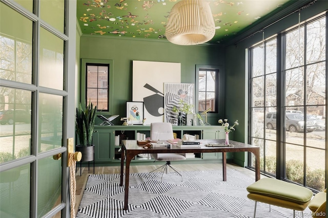 home office featuring crown molding and wood finished floors