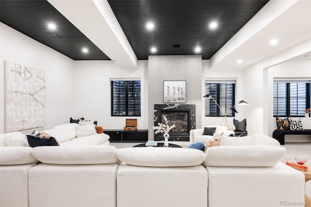 living room featuring recessed lighting and a high end fireplace