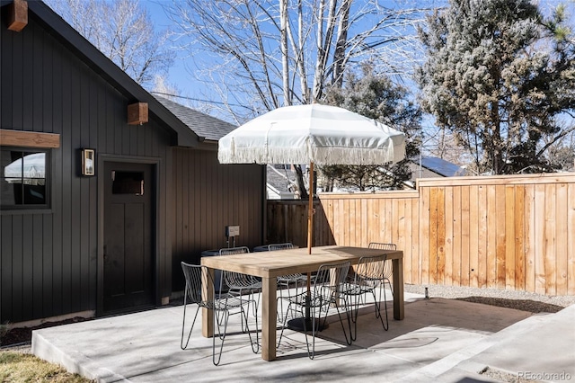 deck featuring a patio area, fence, and outdoor dining area