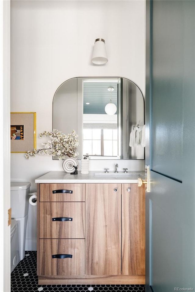 bathroom featuring toilet and vanity