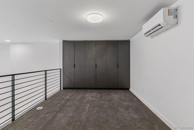 unfurnished bedroom featuring dark carpet and a wall mounted AC